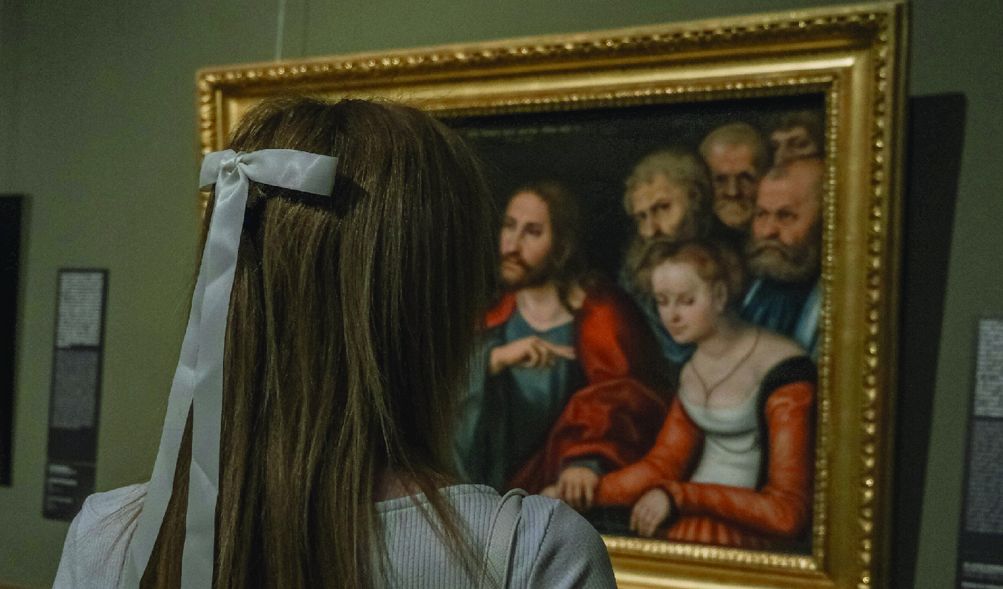 Back View of Woman Standing by Painting on Wall at Art Gallery